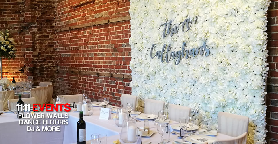 White Rose Flower Wall at Highclifee Castle behind top table for a wedding in Christchurch