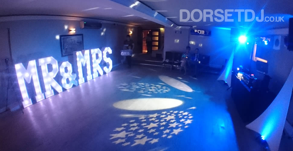 Wedding DJ and Disco with MR and MRS sign with White bulbs at the Christchurch Harbour Hotel